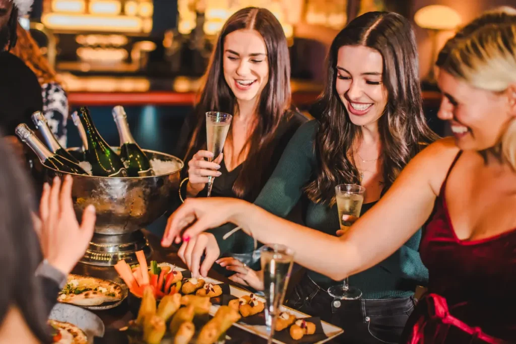 Women sampling food and drinking at Puttshack